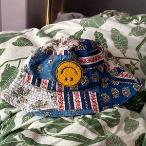 Upside down smiley, blue bucket hat with patterned patches